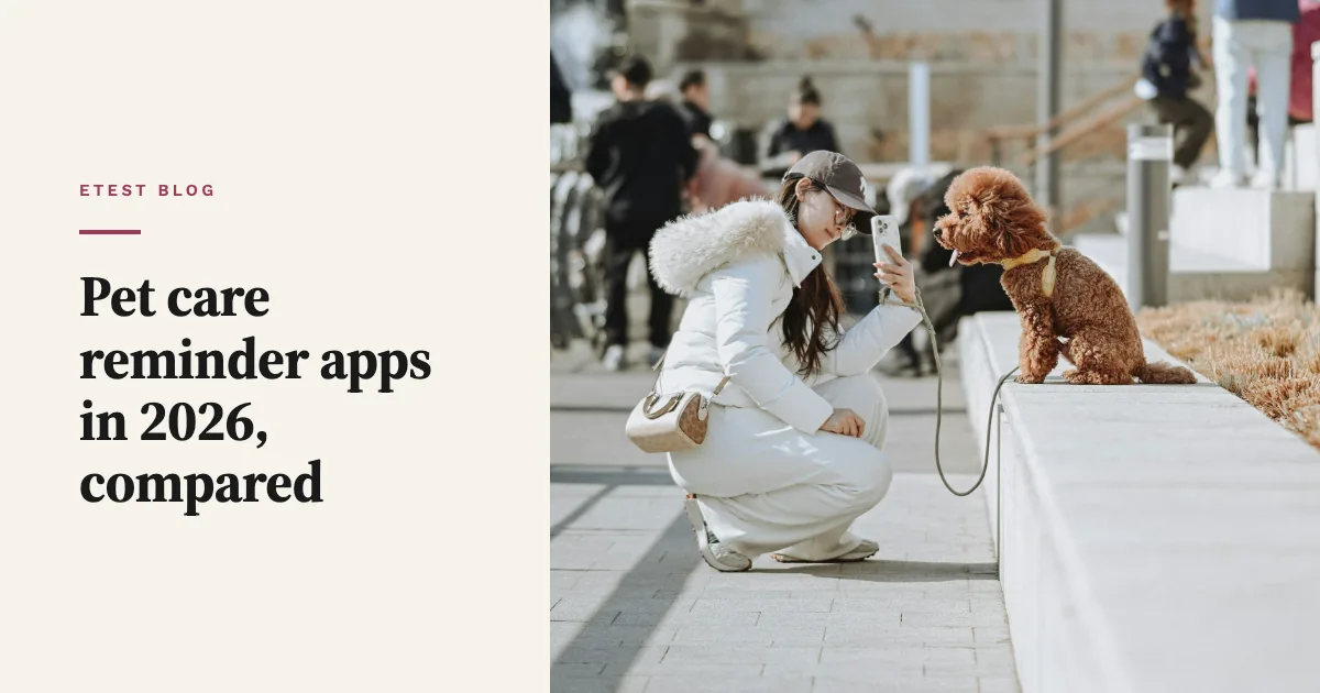 A woman crouches to photograph a brown poodle with her phone