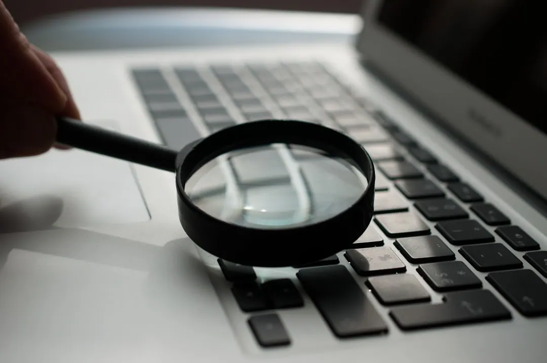 Magnifying glass over a laptop keyboard